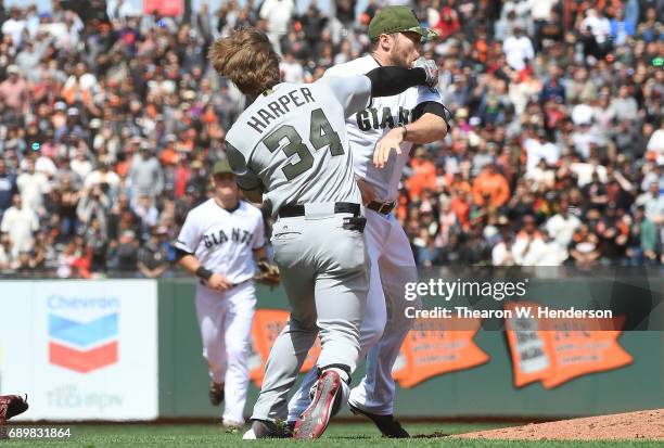 Bryce Harper of the Washington Nationals and Hunter Strickland of the San Francisco Giants throw punches at one another after Strickland hit Harper...