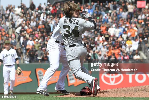 Bryce Harper of the Washington Nationals and Hunter Strickland of the San Francisco Giants throw punches at one another after Strickland hit Harper...