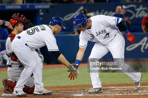 Toronto Blue Jays catcher Russell Martin greets Toronto Blue Jays shortstop Troy Tulowitzki at home plate after Tulo's massive Grand Slam. Toronto...