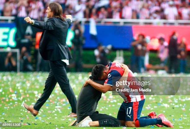 Jesús Sánchez of Chivas celebrates the championship as his coach Matias Almeyda walks behind him after winning the Final second leg match between...