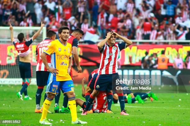 Damian Alvarez of Tigres looks disappointed as Jesús Sánchez of Chivas reacts after winning the Final second leg match between Chivas and Tigres UANL...