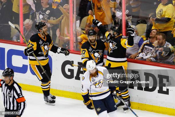 Nick Bonino of the Pittsburgh Penguins celebrates a goal during the first period with teammates Bryan Rust and Carter Rowney of the Pittsburgh...
