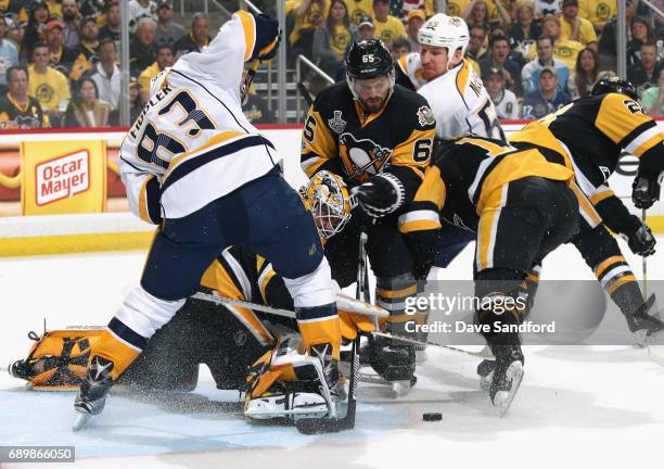 Goaltender Matt Murray of the Pittsburgh Penguins makes a save underneath Vernon Fiddler of the Nashville Predators as teammate Ron Hainsey looks on...