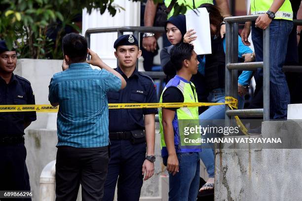 Vietnamese national Doan Thi Huong is escorted by Malaysian police after a court appearance with Indonesian national Siti Aisyah at the Sepang...