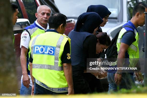 Indonesian national Siti Aisyah is escorted by Malaysian police for a court appearance with Vietnamese national Doan Thi Huong at the Sepang...