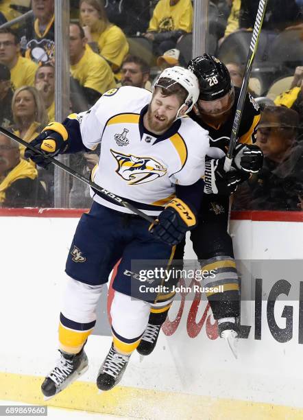 Austin Watson of the Nashville Predators checks Ian Cole of the Pittsburgh Penguins during the first period of Game One of the 2017 NHL Stanley Cup...