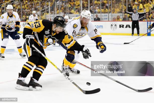 Conor Sheary of the Pittsburgh Penguins is pressured by Mattias Ekholm of the Nashville Predators during the first period of Game One of the 2017 NHL...