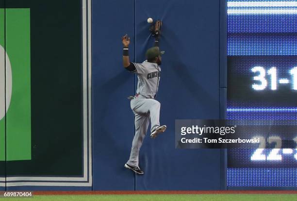 Arismendy Alcantara of the Cincinnati Reds can't come up with the ball that went for a double off the bat of Kendrys Morales of the Toronto Blue Jays...
