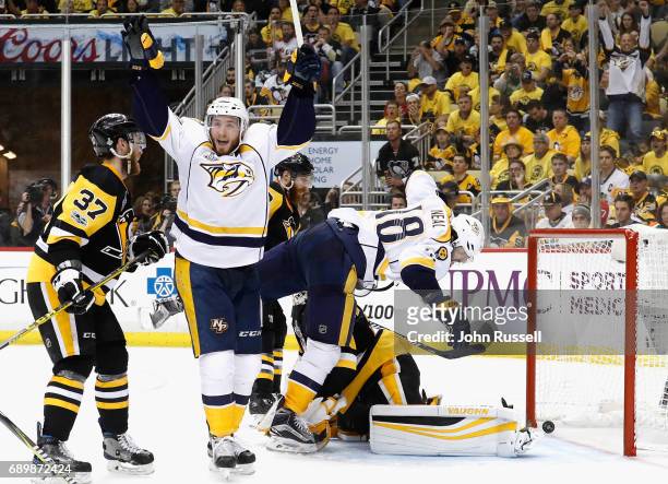 Colton Sissons of the Nashville Predators celebrates his goal as teammates James Neal falls over goaltender Matt Murray of the Pittsburgh Penguins...