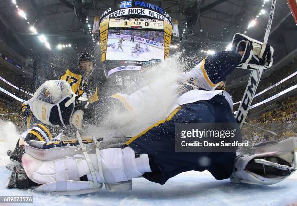 Goaltender Pekka Rinne of the Nashville Predators is sprayed with ice by Bryan Rust of the Pittsburgh Penguins during the first period of Game One of...
