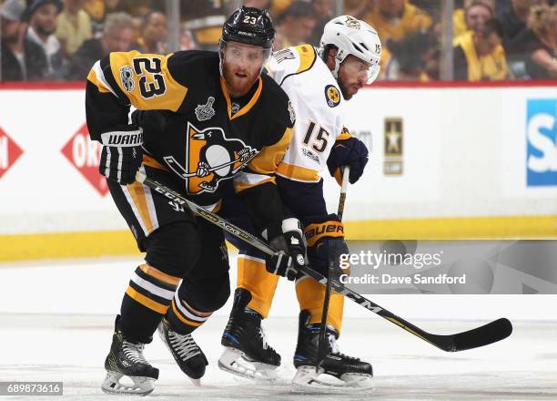 Scott Wilson of the Pittsburgh Penguins plays against Craig Smith of the Nashville Predators during the first period of Game One of the 2017 NHL...