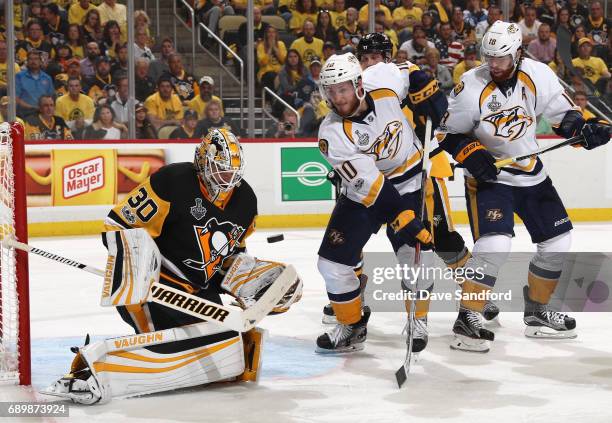 Goaltender Matt Murray of the Pittsburgh Penguins makes a save as Colton Sissons and James Neal of the Nashville Predators look on during the third...