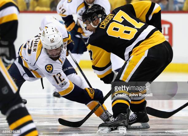 Sidney Crosby of the Pittsburgh Penguins faces off against Mike Fisher of the Nashville Predators during the third period of Game One of the 2017 NHL...