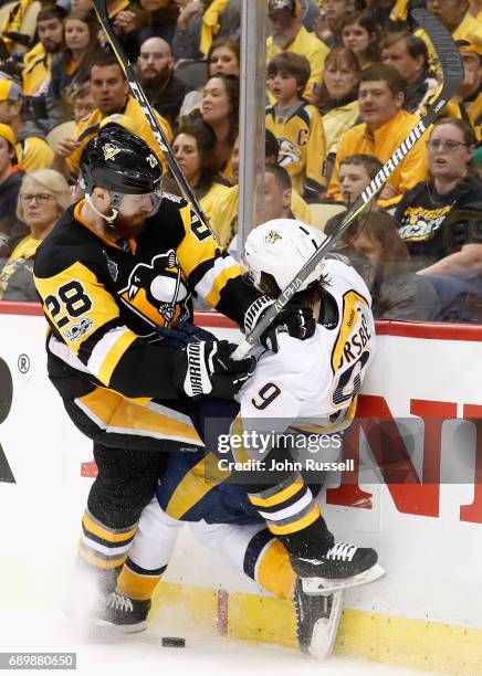 Ian Cole of the Pittsburgh Penguins checks Filip Forsberg of the Nashville Predators to the boards during the third period of Game One of the 2017...