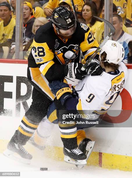 Ian Cole of the Pittsburgh Penguins checks Filip Forsberg of the Nashville Predators to the boards during the third period of Game One of the 2017...