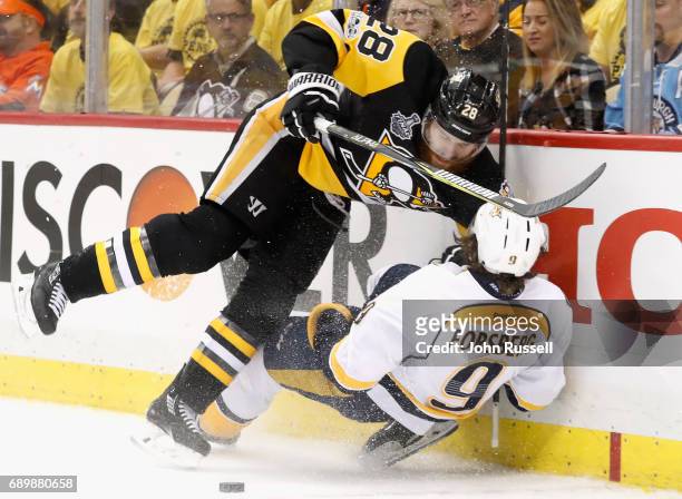 Ian Cole of the Pittsburgh Penguins checks Filip Forsberg of the Nashville Predators to the boards during the third period of Game One of the 2017...