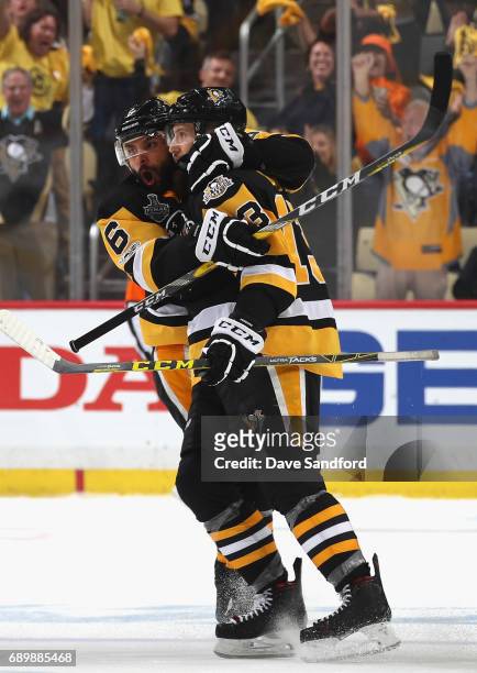 Trevor Daley of the Pittsburgh Penguins celebrates with Nick Bonino after Bonino scored an empty net goal during the third period of Game One of the...