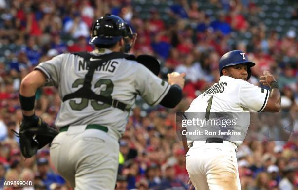 Elvis Andrus of the Texas Rangers is caught in a rundown as Derek Norris of the Tampa Bay Rays closes in for the out during the third inning at Globe...