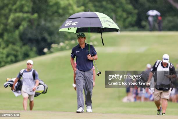 Kevin Kisner carries an umbrella up to the 8th green during the final round of the PGA Dean & Deluca Invitational on May 28, 2017 at Colonial Country...