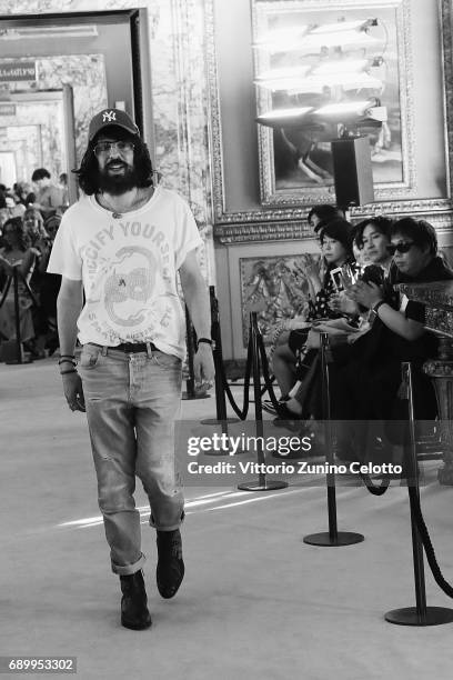 Designer Alessandro Michele acknowledges the applause of the public after the Gucci Cruise 2018 show at Palazzo Pitti on May 29, 2017 in Florence,...