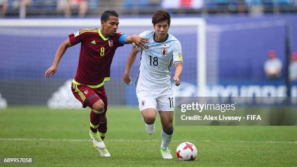 Akito Takagi of Japan holds off a challenge from Yangel Herrera of Venezuela during the FIFA U-20 World Cup Korea Republic 2017 Round of 16 match...