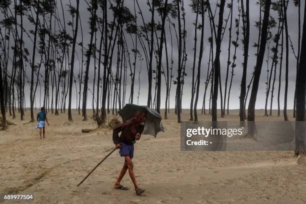 Bangladeshi villager evacuates to a cyclone shelter on the coast in Cox's Bazar district on May 30, 2017. - Cyclone Mora hit Bangladesh on May 30,...