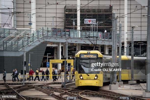 Passengers make their way through Manchester Victoria railway station which has reopened one week after being the the scene of a terror attack in...