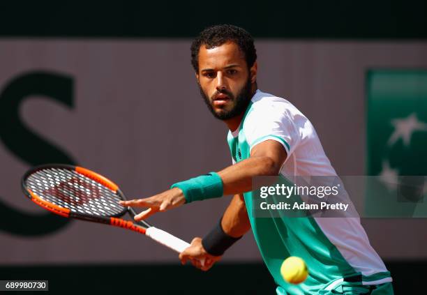 Laurent Lokoli of France plays a forehand during the mens singles first round match against Martin Klizan of Slovakia on day three of the 2017 French...