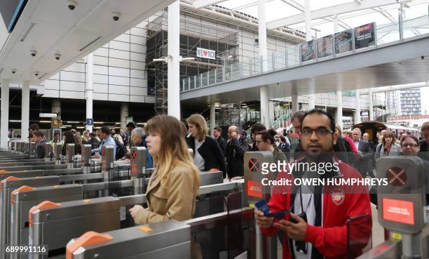 Commuters make their way through Manchester Victoria railway station which has reopened one week after being the the scene of a terror attack in...