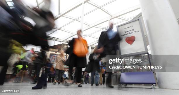 Commuters make their way through Manchester Victoria railway station which has reopened one week after being the the scene of a terror attack in...