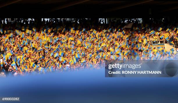 Supporters of Braunschweig wave flags during German Bundesliga relegation second leg football match between Eintracht Braunschweig and VfL Wolfsburg...