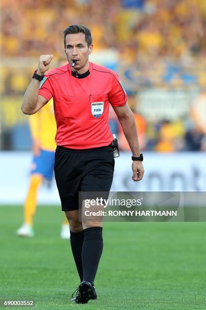 Referee Tobias Stieler gestures during German Bundesliga relegation second leg football match between Eintracht Braunschweig and VfL Wolfsburg on May...