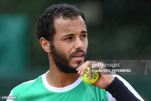 France's Laurent Lokoli looks on as he plays against Slovakia's Martin Klizan during their tennis match at the Roland Garros 2017 French Open on May...