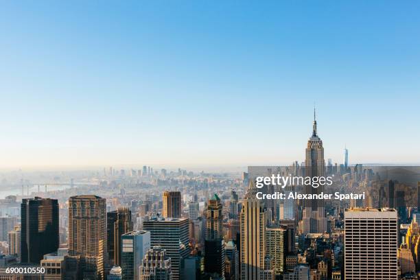 new york city cityscape in the morning with clear blue sky - centro de nueva york fotografías e imágenes de stock