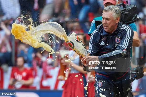 Head coach Carlo Ancelotti of Bayern Muenchen celebrates with beer after the Bundesliga match between Bayern Muenchen and SC Freiburg at Allianz...