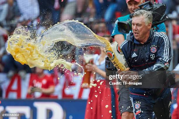 Head coach Carlo Ancelotti of Bayern Muenchen celebrates with beer after the Bundesliga match between Bayern Muenchen and SC Freiburg at Allianz...