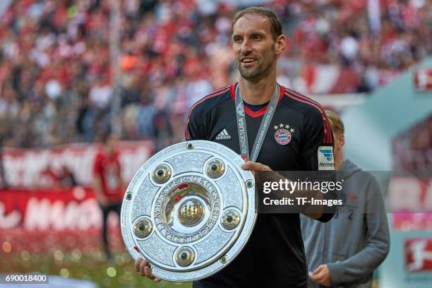 Goalkeeper Tom Starke of Bayern Muenchen poses with the Championship trophy in celebration of the 67th German Championship title following he...