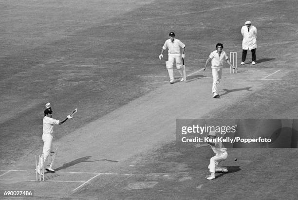 Australian opening batsman Alan Turner plays a shot past England fielder Bob Woolmer off the bowling of John Snow during the 2nd Test match between...