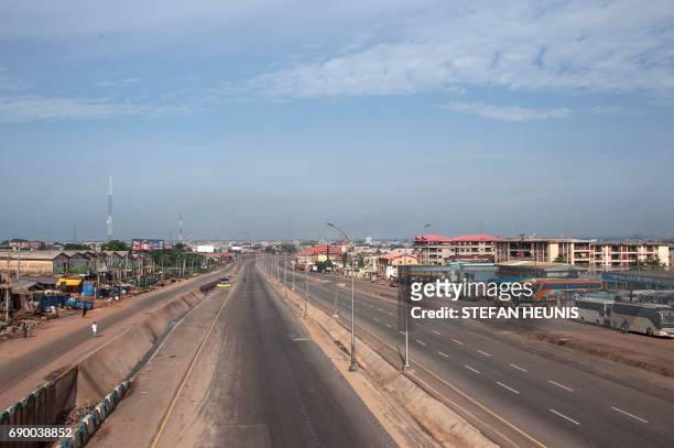 Photo shows a view of an empty highway running past the Ogbaru Market in Onitsha on May 30 during a shutdown in commemoration of the 50th anniversary...
