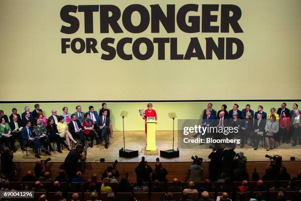 Nicola Sturgeon, Scotland's first minister and leader of the Scottish National Party , holds a copy of the party's general-election manifesto during...