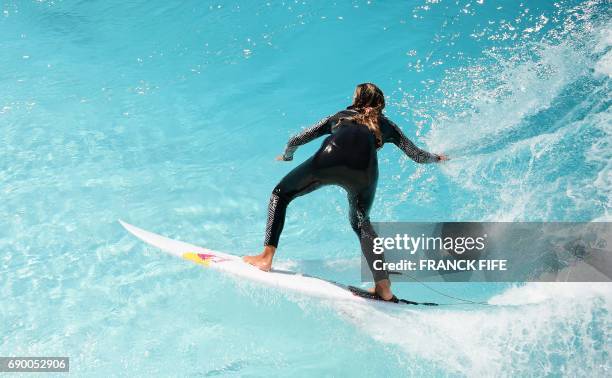 France's surfer Justine Dupont trains at Wave Garden, a large inland pool that generates waves during a training session May 25, 2017 in...