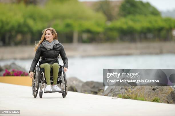 young woman using a wheelchair - coraggio stock pictures, royalty-free photos & images