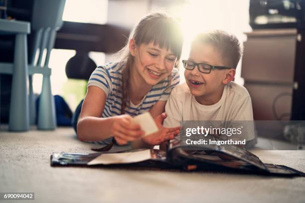 Brother and sister looking at photo album