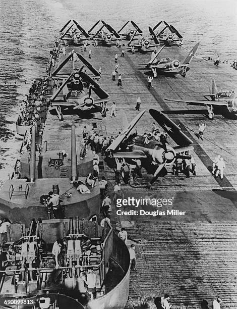 Curtiss SBC Helldiver two-seat scout bomber and dive bomber prepare for take off from the flight deck of an aircraft carrier of the United States...