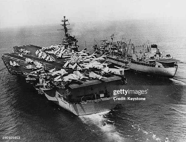 Aerial view of aircraft lined up on the flight deck of the Forrestal-class aircraft carrier the USS Saratoga of the United States Navy as she is...