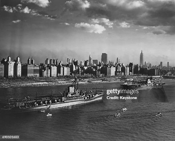 With the Empire State Building and the Manhattan skyline as a backdrop the aircraft carriers USS Midway and the USS Enterprise of the United States...