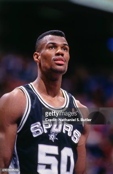 David Robinson of the San Antonio Spurs looks on during the game against the New Jersey Nets circa 1993 at the Brendan Byrne Arena in East...