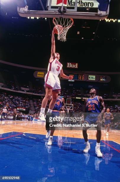 Drazen Petrovic of the New Jersey Nets goes for a dunk during the game against the New York Knicks circa 1993 at the Brendan Byrne Arena in East...