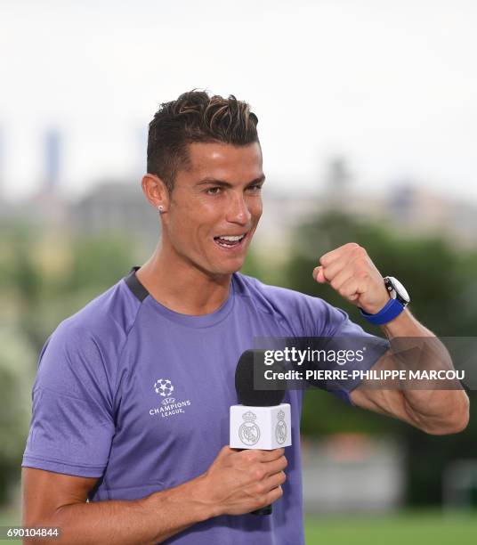 Real Madrid's Portuguese forward Cristiano Ronaldo gestures in the mixed zone at Valdebebas Sport City in Madrid on May 30, 2017 at the Media Day...