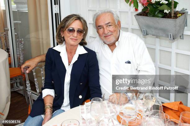 Dominique Strauss-Kahn and his companion Myriam L'Aouffir attend the 2017 French Tennis Open - Day Three at Roland Garros on May 30, 2017 in Paris,...